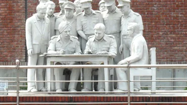 a statue of a group of men standing next to each other