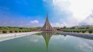 a pyramid shaped building sitting in the middle of a lake